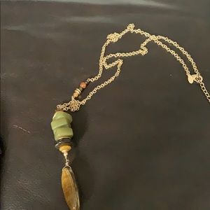 Gold necklace with green and brown stones.